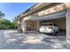 Two car garage with a white SUV inside, and a well manicured green lawn outside the garage at 1115 Gladstone Blvd, Englewood, FL 34223