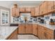 Spacious kitchen with granite counters, tile backsplash, wooden cabinets, and stainless steel appliances at 1115 Gladstone Blvd, Englewood, FL 34223