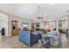 Spacious living room featuring wood floors, a ceiling fan, comfortable seating, and neutral paint at 1115 Gladstone Blvd, Englewood, FL 34223