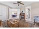 Open concept living room with a ceiling fan, decorative rug, and views to the living room and bathroom at 1115 Gladstone Blvd, Englewood, FL 34223