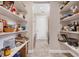 A well stocked walk-in pantry with shelves of food and supplies at 1115 Gladstone Blvd, Englewood, FL 34223