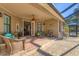 The covered patio offers a cozy sitting area and access to the pool deck, perfect for outdoor entertaining at 1115 Gladstone Blvd, Englewood, FL 34223