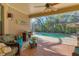 Relaxing screened lanai features comfortable seating and serene views of the pool and backyard at 1115 Gladstone Blvd, Englewood, FL 34223