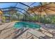 The screened pool offers a private oasis for relaxation and recreation, surrounded by lush greenery at 1115 Gladstone Blvd, Englewood, FL 34223