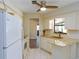 Bright kitchen with white appliances, granite countertops, and ample cabinet space at 11208 Grafton Ave, Englewood, FL 34224