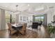 Elegant living room with a coffered ceiling, natural light, and seamless indoor-outdoor flow at 11644 Okaloosa Dr, Venice, FL 34293