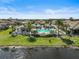 Community pool and pool-house featuring resort-style amenities and lush landscaping at 11644 Okaloosa Dr, Venice, FL 34293