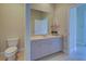 Traditional bathroom featuring a large mirror, soft-tone vanity, and tile flooring at 126 Wading Bird Dr, Venice, FL 34292