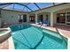 Outdoor pool and spa with lounge seating and brick patio at 126 Wading Bird Dr, Venice, FL 34292