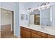 Dual sinks and vanity are reflected in a large bathroom mirror at 13240 Amerigo Ln, Venice, FL 34293