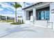 Inviting building exterior with white columns, glass doors, manicured lawn, and walkway at 13240 Amerigo Ln, Venice, FL 34293