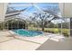 Enclosed swimming pool with a screen enclosure and surrounding deck for entertaining and relaxation at 1358 Ewing St, Nokomis, FL 34275