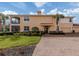 Inviting two-story home features a lush lawn, brick walkway, and attached garages at 142 Bella Vista Ter # A, North Venice, FL 34275