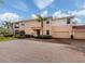 Spacious home with a brick driveway, two-car garage, lush landscaping, and attractive curb appeal at 142 Bella Vista Ter # A, North Venice, FL 34275