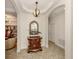 Hallway featuring an ornate mirror over an elegant dresser leading into the living room at 142 Bella Vista Ter # A, North Venice, FL 34275