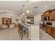 Well-lit kitchen with stainless steel appliances, pendant lighting, and granite countertops at 142 Bella Vista Ter # A, North Venice, FL 34275