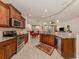 Spacious kitchen showcasing granite countertops, stainless steel appliances, and a breakfast nook at 142 Bella Vista Ter # A, North Venice, FL 34275