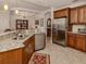 Modern kitchen with granite countertops, stainless steel appliances and a large refrigerator at 142 Bella Vista Ter # A, North Venice, FL 34275