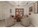 Neutral living area featuring custom light fixture, built-in bookcase, and comfortable furniture at 142 Bella Vista Ter # A, North Venice, FL 34275