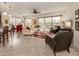 Bright living room with large windows, a ceiling fan, and comfortable seating at 142 Bella Vista Ter # A, North Venice, FL 34275