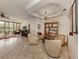 Open living room featuring a unique light fixture, neutral furniture, and bright natural lighting at 142 Bella Vista Ter # A, North Venice, FL 34275