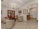 Neutral living area with an ornate light fixture and an elegant built-in bookcase on display at 142 Bella Vista Ter # A, North Venice, FL 34275