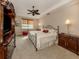 Spacious main bedroom with a ceiling fan and a neutral color scheme for a relaxing atmosphere at 142 Bella Vista Ter # A, North Venice, FL 34275