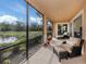 Inviting screened-in patio with comfortable seating and picturesque water views at 142 Bella Vista Ter # A, North Venice, FL 34275
