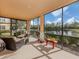 Screened porch offering seating with serene water views and lush greenery at 142 Bella Vista Ter # A, North Venice, FL 34275