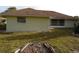 Exterior rear view showing an open backyard and a screened-in porch at 157 Algiers Dr, Venice, FL 34293