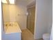 A well lit bathroom featuring a single sink vanity with ample lighting and a sliding glass shower door at 157 Algiers Dr, Venice, FL 34293