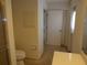 Bright bathroom featuring a toilet and single sink vanity next to a doorway at 157 Algiers Dr, Venice, FL 34293