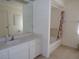 This bathroom has a shower-tub combo and single-sink vanity with ample lighting and neutral decor at 157 Algiers Dr, Venice, FL 34293