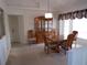 Warm dining area with wood furnishings and large bright window that brings in natural light at 157 Algiers Dr, Venice, FL 34293
