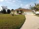 Inviting single-story home with an attached two-car garage, long driveway, and well-maintained lawn at 157 Algiers Dr, Venice, FL 34293