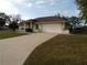 Charming single-story home featuring an attached two-car garage, large driveway and well-manicured lawn at 157 Algiers Dr, Venice, FL 34293