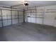 Large two-car garage with shelving, a concrete floor, and a white garage door at 157 Algiers Dr, Venice, FL 34293