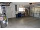 Spacious two-car garage with painted walls, concrete floor, shelving, and garage door at 157 Algiers Dr, Venice, FL 34293