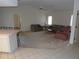 Open-concept living area with carpeted floors and neutral walls next to the kitchen at 157 Algiers Dr, Venice, FL 34293