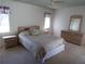 Comfortable main bedroom featuring a coordinated furniture set, and windows with coverings at 157 Algiers Dr, Venice, FL 34293