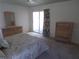 Bright main bedroom featuring a dresser, chest of drawers, and a sliding glass door to the lanai at 157 Algiers Dr, Venice, FL 34293