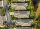 An aerial view of the homes showcases the well-manicured lawns, driveways, and landscaping in the neighborhood at 1610 Monarch Dr # 1610, Venice, FL 34293