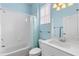 Bathroom with a combined tub and shower, a blue shower curtain, and a sink with cabinets at 1610 Monarch Dr # 1610, Venice, FL 34293