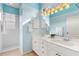Bright bathroom with a double sink vanity and shower, with light blue walls at 1610 Monarch Dr # 1610, Venice, FL 34293