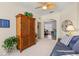 Bedroom with a couch, armoire, and ceiling fan, connecting to the dining room at 1610 Monarch Dr # 1610, Venice, FL 34293
