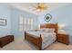 Serene bedroom featuring a wooden bed frame and shuttered window at 1610 Monarch Dr # 1610, Venice, FL 34293