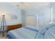 Bedroom with blue striped bedding, a ceiling fan, and ensuite bathroom access at 1610 Monarch Dr # 1610, Venice, FL 34293