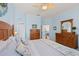 Bedroom with light blue walls and wood furniture, connecting to the living room at 1610 Monarch Dr # 1610, Venice, FL 34293