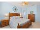 Charming bedroom with wood furniture, light blue walls, and a decorative quilt at 1610 Monarch Dr # 1610, Venice, FL 34293