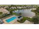 Community pool with a covered pavilion and lounge chairs near a scenic pond at 1610 Monarch Dr # 1610, Venice, FL 34293
